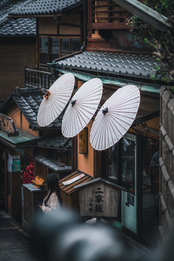 Charming street scene in Kyoto, Japan featuring traditional umbrellas. Captures the essence of Japanese culture.